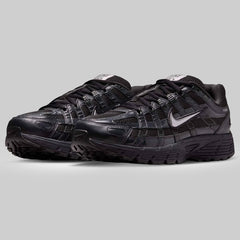 Black Nike sneakers on a gray background