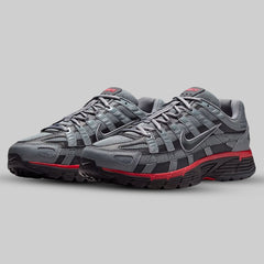 Gray running shoes with red accents on a gray background