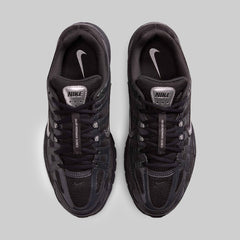 Black Nike sneakers on a gray background