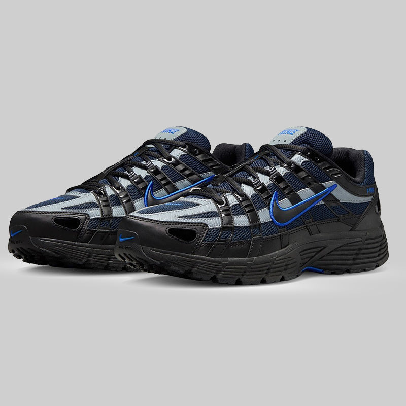 Black and blue athletic Trainers pair on a gray background mens shoes