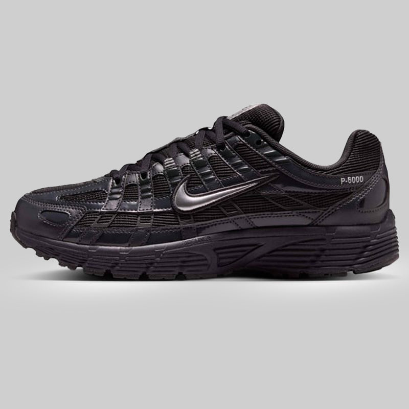 Black athletic shoe with Nike logo on a gray background