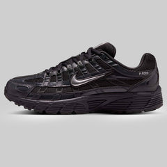 Black athletic shoe with Nike logo on a gray background