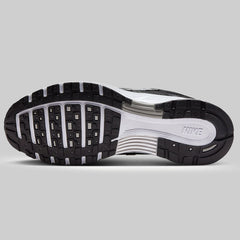 Close-up of a black and white sneaker sole on a gray background